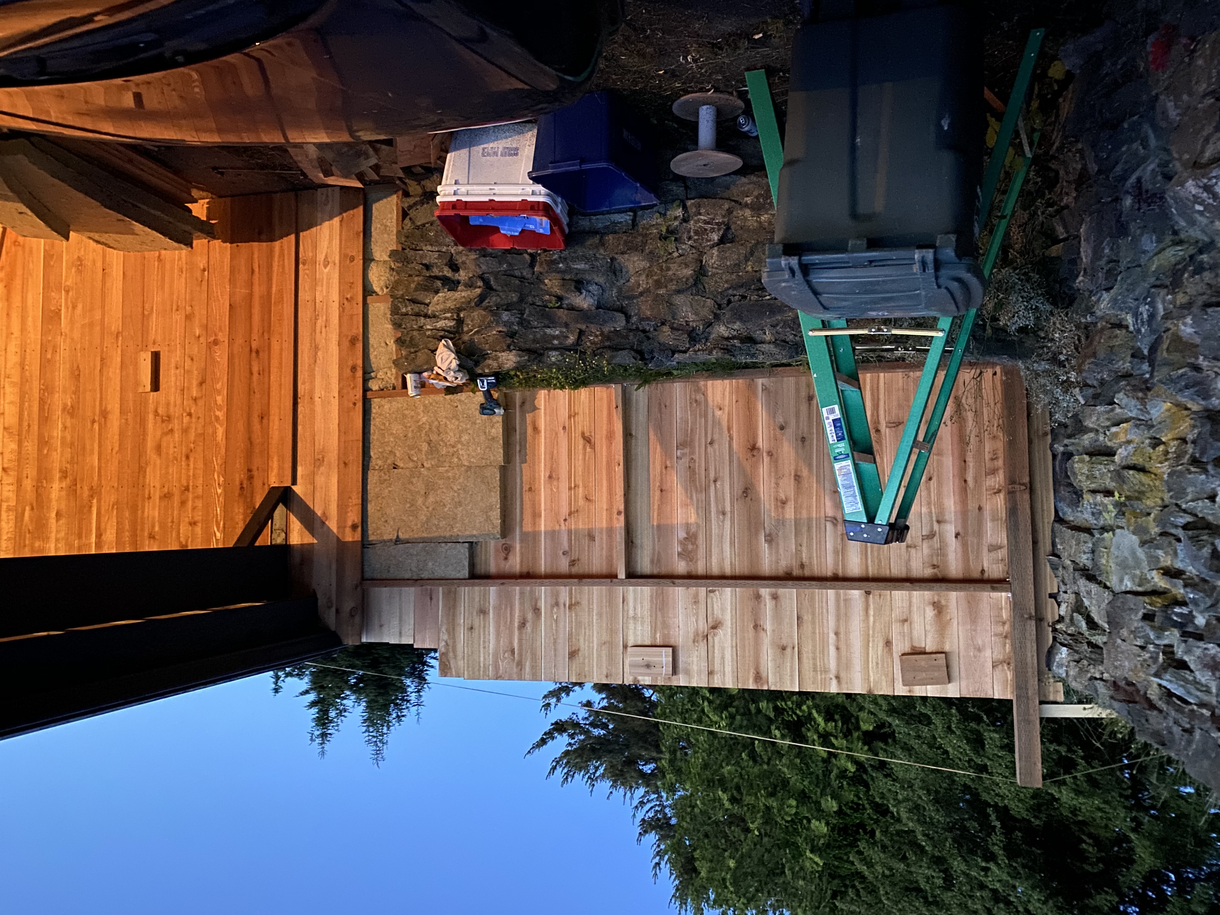 Cedar fence installation at dusk