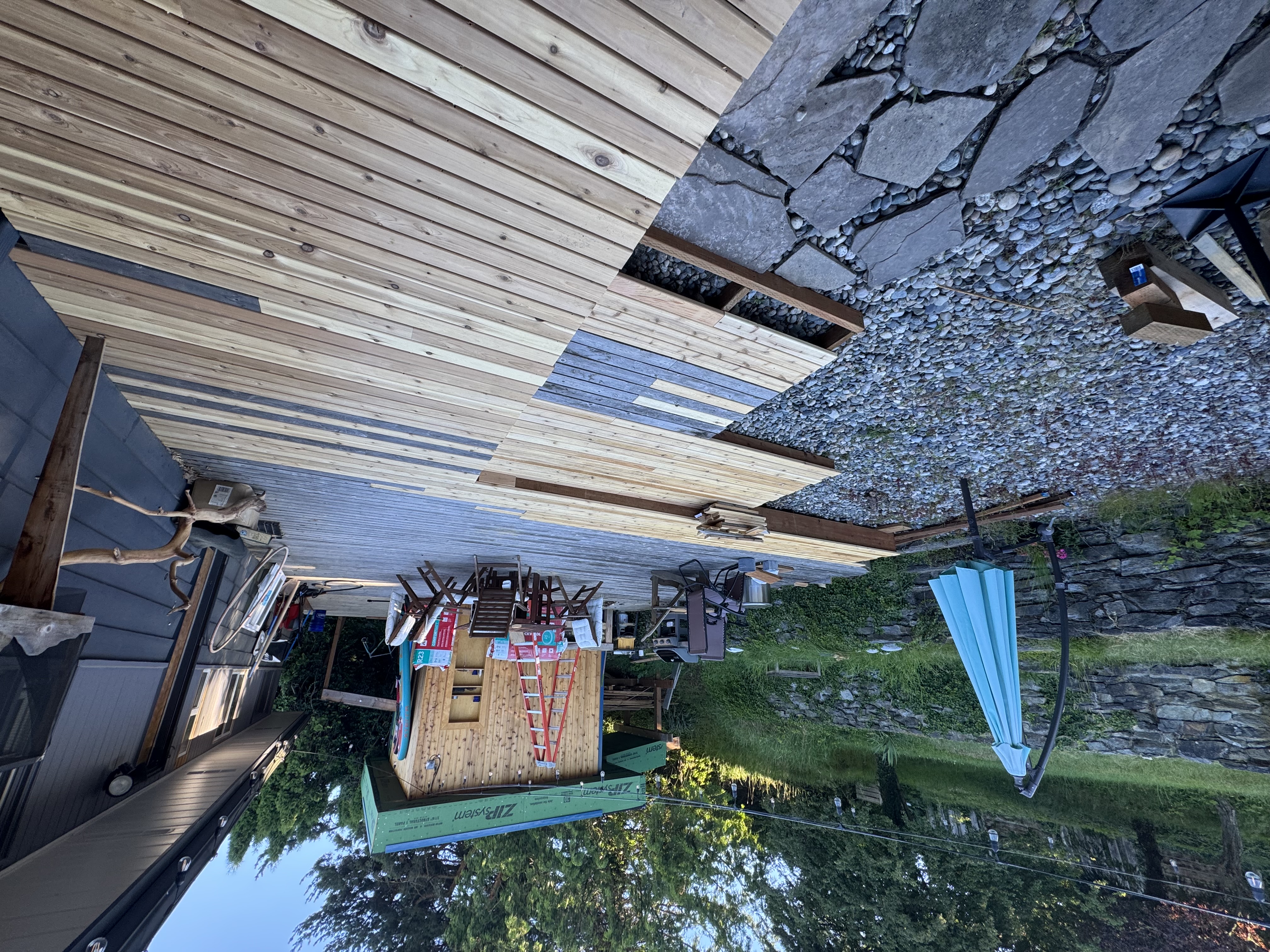 Covered pergola over a natural stone patio
