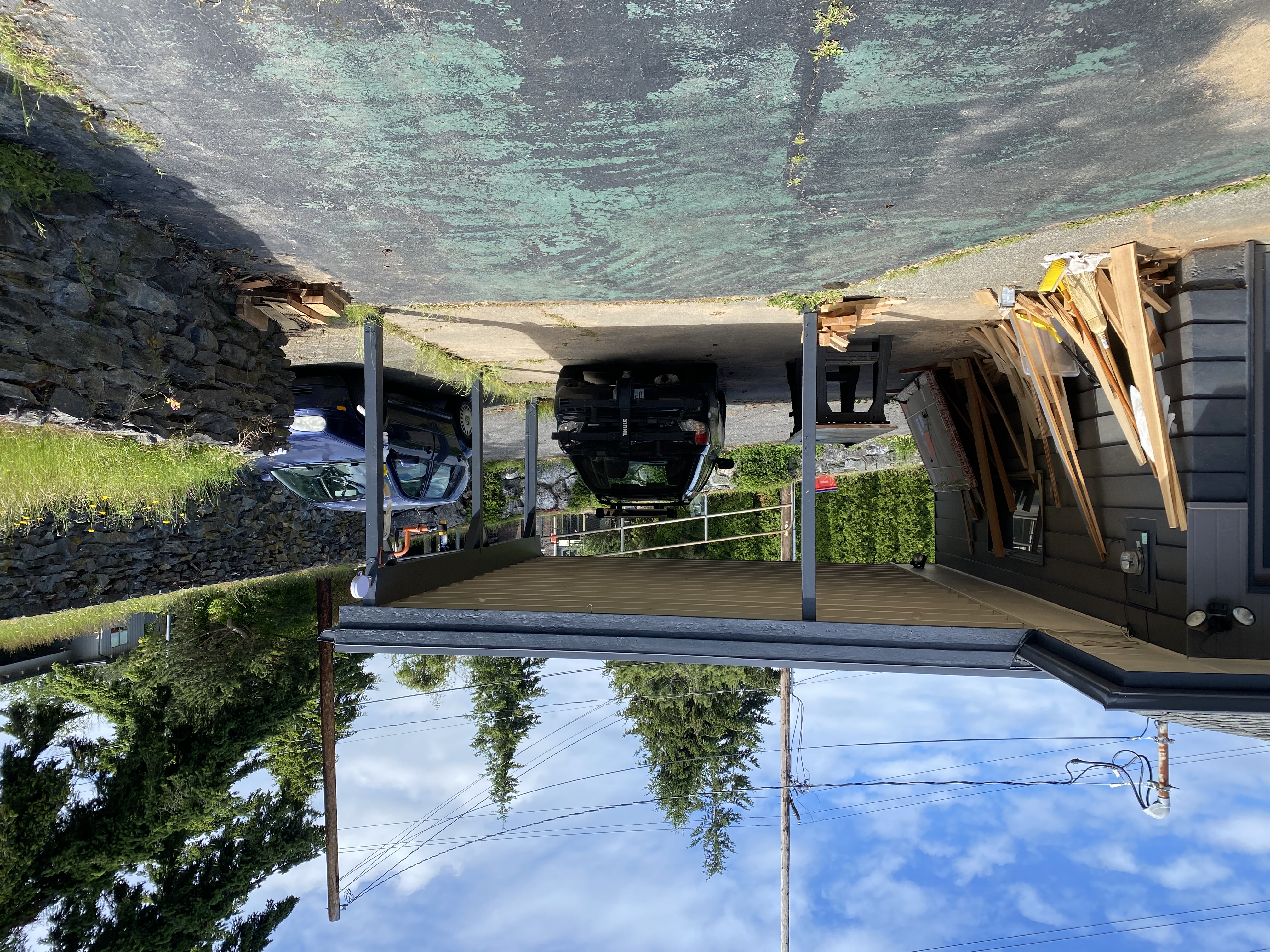 Carport structure beneath an elevated deck